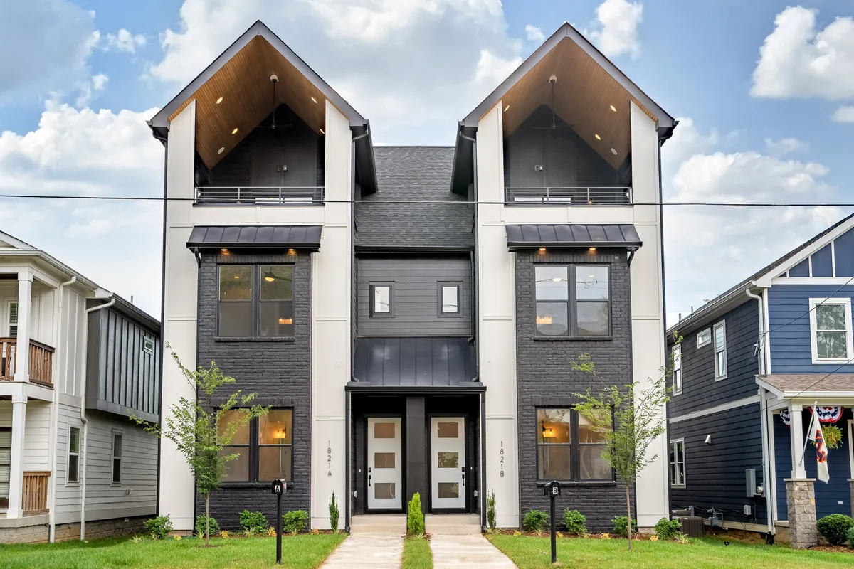 The entrance of a modern home with symmetrical design, large windows, and an inviting front area, illustrating the blend of historic inspiration and contemporary appeal that characterizes the neighborhood.